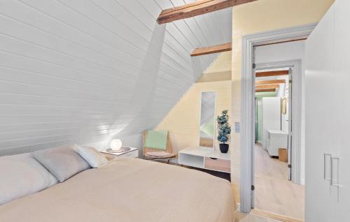 a white bedroom with a bed and a staircase at Nice Home In Oksbl With Kitchen in Oksbøl