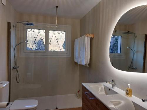 a bathroom with a sink and a shower and a mirror at Le Chalet des O in Saint-Lary-Soulan