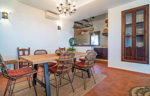 a kitchen and dining room with a wooden table and chairs at Amazing Home In Algarrobo With Wifi in Algarrobo