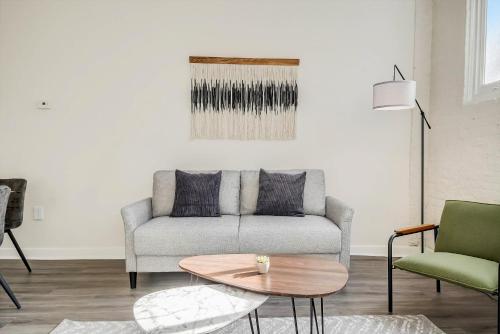 a living room with a couch and a table at CozySuites - 2BR with Direct Skybridge Access #9 in Indianapolis