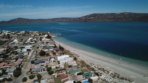 an aerial view of a beach with houses and the water at The Farmhouse Hotel in Langebaan
