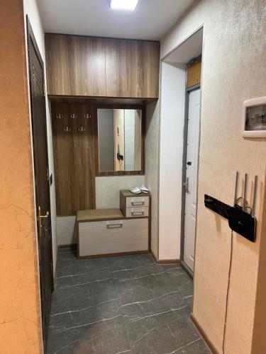 a room with a bathroom with a sink and a mirror at Cozy nest in Baku
