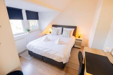 a bedroom with a bed with white sheets and pillows at Peaceful 2 Bedroom Apartment - TS307B in Eindhoven