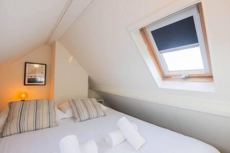 a white bed in a room with a window at Peaceful 2 Bedroom Apartment (TS-307-B) in Eindhoven