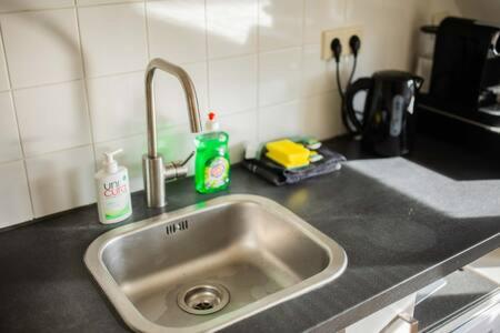 a kitchen counter with a sink in a kitchen at Peaceful 2 Bedroom Apartment (TS-307-B) in Eindhoven