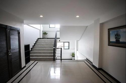 a hallway with stairs and a stair case at The Season Airport Udonthani in Udon Thani