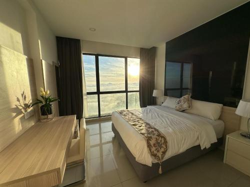 a bedroom with a large bed and a large window at Premium Family 3BR Genting Ion Delemen in Genting Highlands