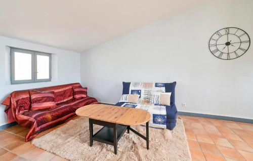 a living room with a couch and a table at 2 Bedroom Lovely Apartment In Beaucaire in Beaucaire