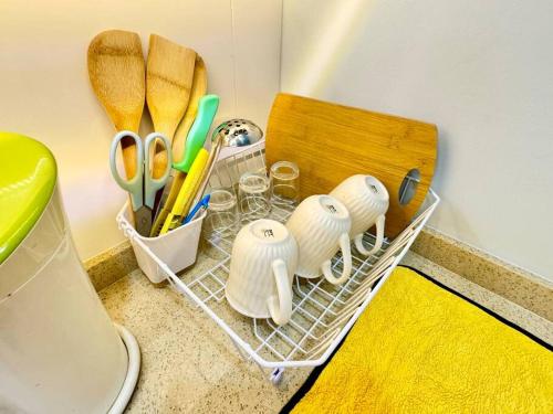 a drying rack with scissors and other utensils on a counter at Decozy7.0 Ipoh Town Condo(12pax) in Ipoh
