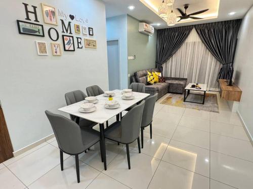 a dining table and chairs in a living room at Decozy7.0 Ipoh Town Condo(12pax) in Ipoh
