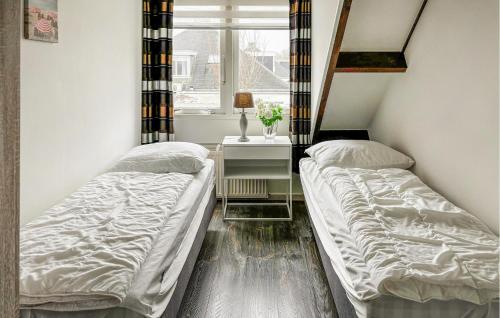 2 camas en una habitación con ventana en Oud Kempen Bungalow 181 en Stavenisse