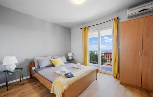 a bedroom with a bed and a large window at Nice Home In Primosten With 5 Bedrooms, Wifi And Outdoor Swimming Pool in Primošten