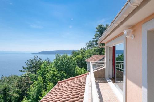 a balcony of a house with a view of the water at Villa Pia in Brseč