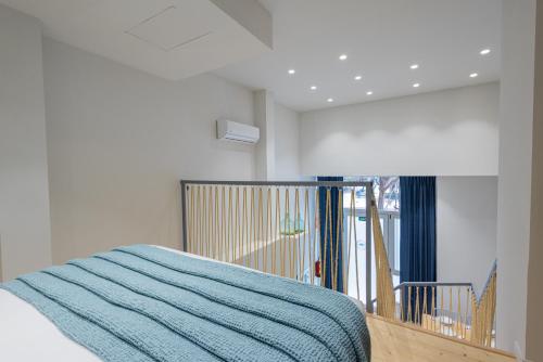 a bedroom with a bed with a blue blanket at FLORIT FLATS - The Seagull Apartments in Valencia