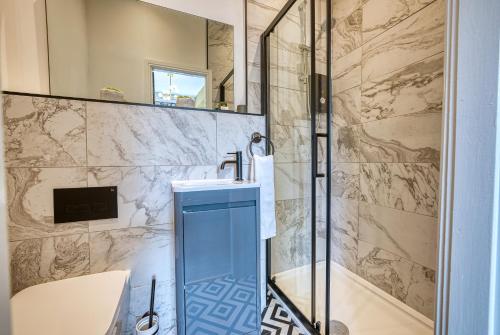 a bathroom with a sink and a shower at Haworth Heights - An AMAZING Aparthotel! in Haworth