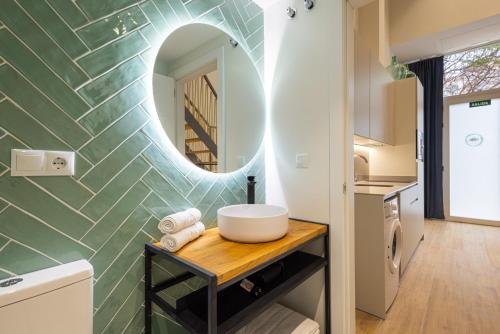 a bathroom with a sink and a mirror at FLORIT FLATS - The Seagull Apartments in Valencia