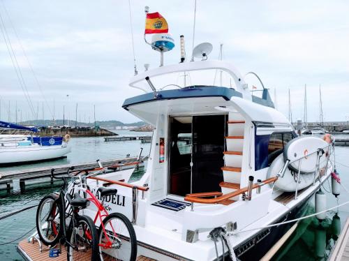 a boat with two bikes parked on the dock at Hotel Boat Cardeli in Gijón