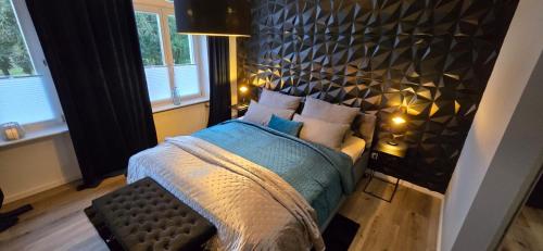 a bedroom with a large bed with a black headboard at Mastersuite in Bad Salzuflen