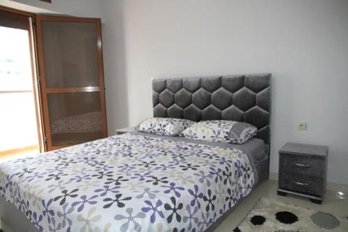 a bedroom with a large bed with a large headboard at Mahaj in Rabat