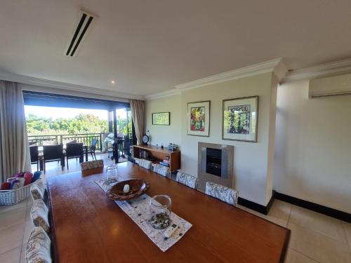 a living room with a couch and a fireplace at Zimbali - Luxury 4 Bedroom KRH1 in Ballito