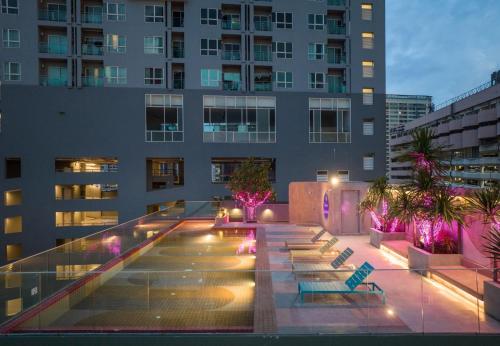 a building with a courtyard with benches and lights at The Quarter Ratchathewi by UHG in Bangkok
