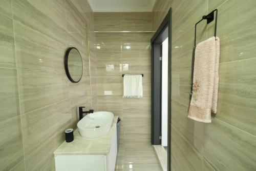 a bathroom with a white sink and a mirror at Villa Mila Fethiye in Fethiye