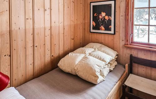 a bedroom with a bed in a wooden wall at 3 Bedroom Stunning Home In Uvdal in Uvdal