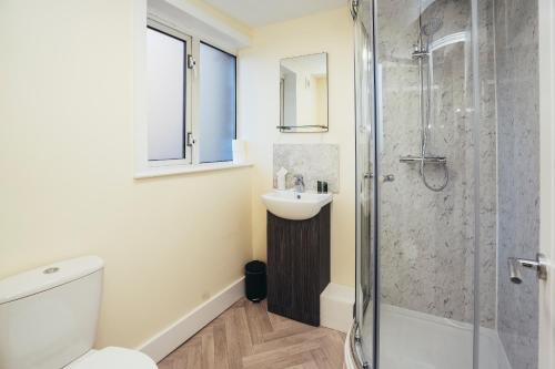 a bathroom with a toilet and a sink and a shower at The Stay Company, Friar Gate Bridge. in Derby