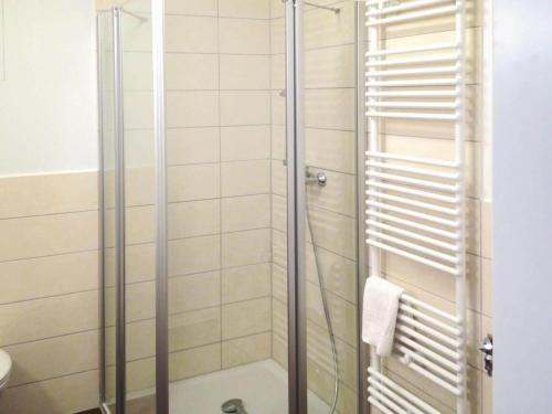 a shower with a glass door in a bathroom at Appartements am Heidensee in Schwerin in Schwerin