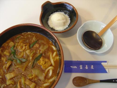 a table with two bowls of soup and a spoon at Fukiya in Gero