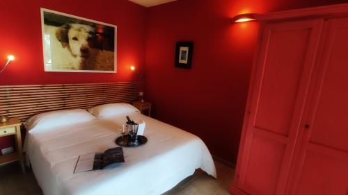 a bedroom with red walls and a white bed at Hotel La Posta di Torrenova in Orbetello