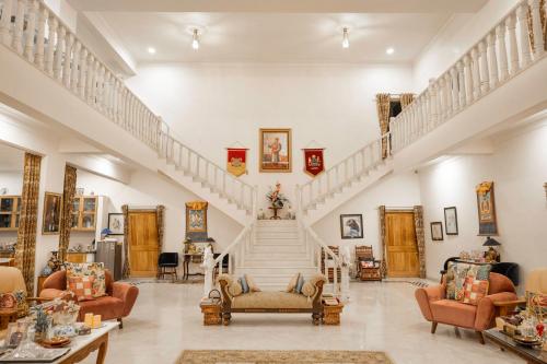 a large living room with stairs and couches at Castle Oodeypore A Boutique stay Udaipur in Udaipur
