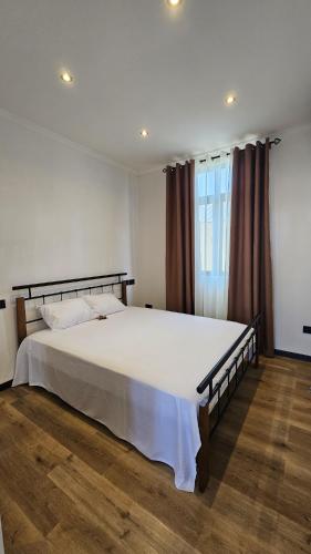 a bedroom with a large bed with white sheets at Residence Oceana 4 in Mont Choisy