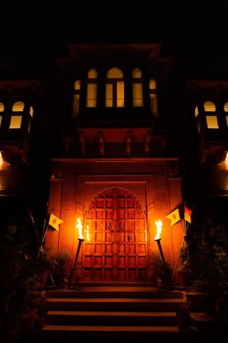 a building with a door at night with lights at Castle Oodeypore A Boutique stay Udaipur in Udaipur