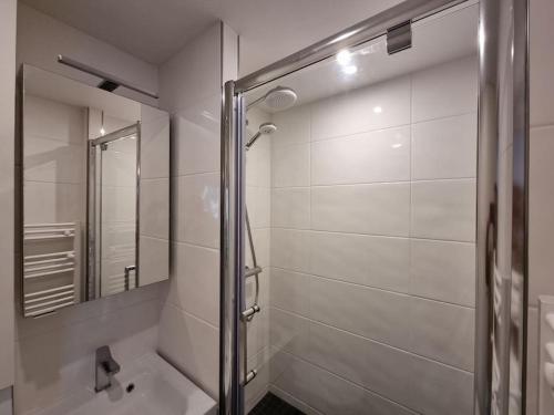 a bathroom with a shower and a mirror at Cosy Plage-Accès privé à la Mer in Cabourg