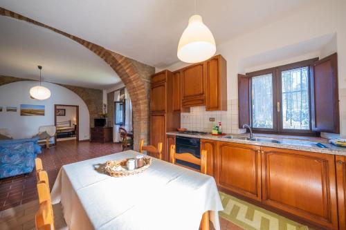 a kitchen with a table and a dining room at Agriturismo il Palagetto in Pomarance