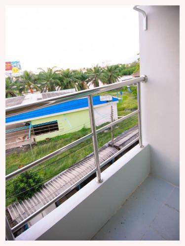 a balcony with a view of a train at Good Morning Apartment in Ban Bang Khan