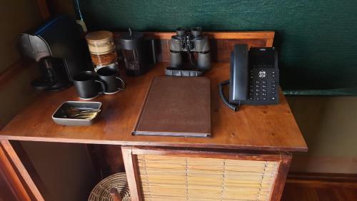 a wooden table with a telephone on top of it at Sky Island Resort in Ponta Malongane