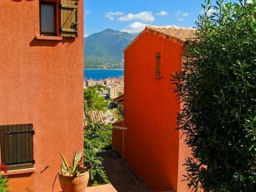 普羅普里亞諾的住宿－Résidence Maquis Bella Vista，一座享有水体景致的橙色建筑