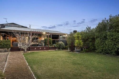 a house with a lawn in front of it at Portarlington Family Fun House in Portarlington
