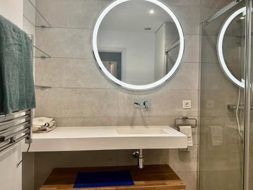 a bathroom with a sink and a mirror at Modern Apartment in front of Cabopino Golf in Cabopino