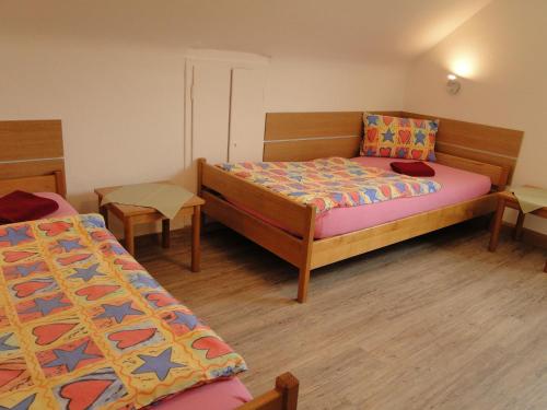 a small bedroom with two beds and a table at Haus St. Josef in Vallendar