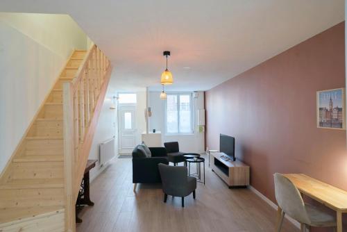 a living room with a staircase and a table and a couch at House in Lille near Euratech private terrace. in Lille