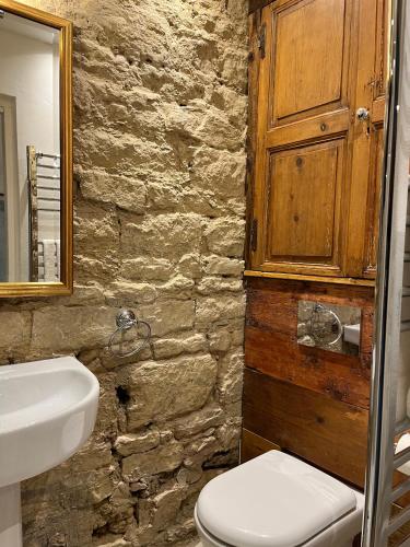 a bathroom with a white toilet and a sink at The Forge in Towcester