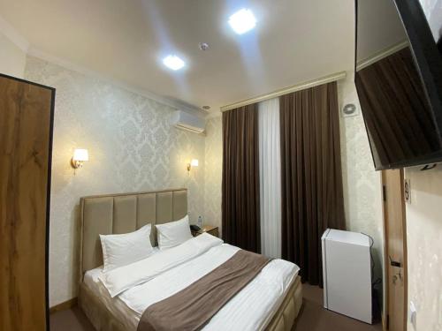 Ein Bett oder Betten in einem Zimmer der Unterkunft HOTEL KARVON SHAHRISABZ