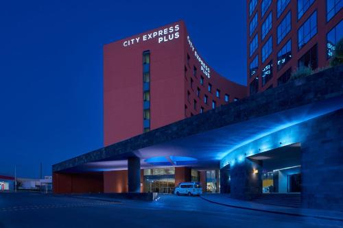 a view of the city synergy building at night at City Express Plus by Marriott San Luis Potosi in San Luis Potosí