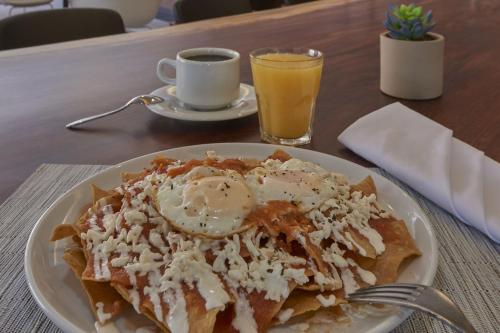 a plate of food with an egg and a cup of coffee at City Express Plus by Marriott San Luis Potosi in San Luis Potosí
