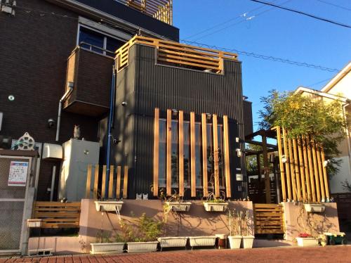 a building with a bunch of wooden benches in front of it at Koke Musu inn in Otsu