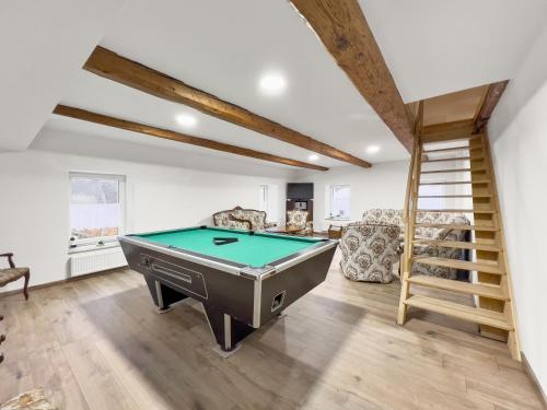 a room with a pool table and a staircase at Marcelína in Mikulov v Krušných Horách