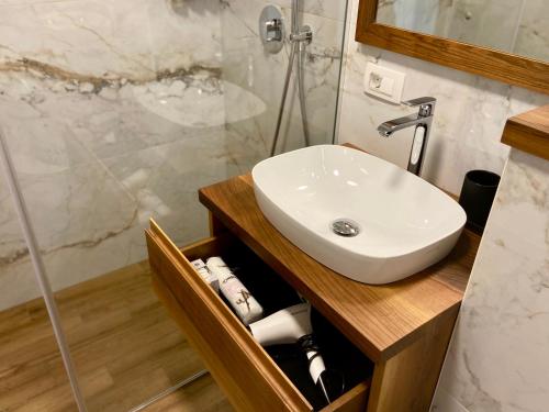 a bathroom with a sink and a shower at Olimian Retreat Rosa 421 in Podčetrtek